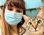 Keeper christina wearing a mask with housecat