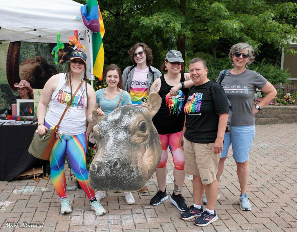 people standing wearing rainbow outfits
