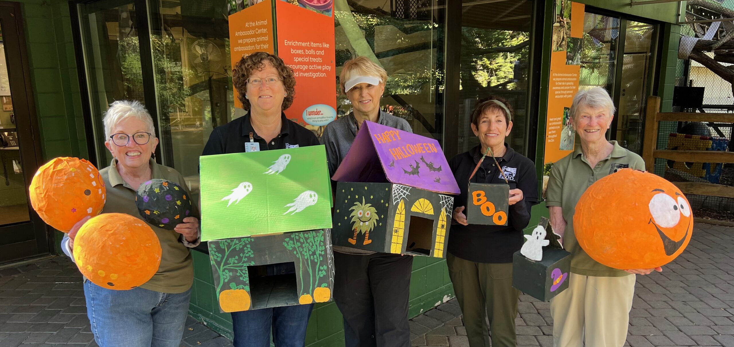 volunteers with halloween enrichment items