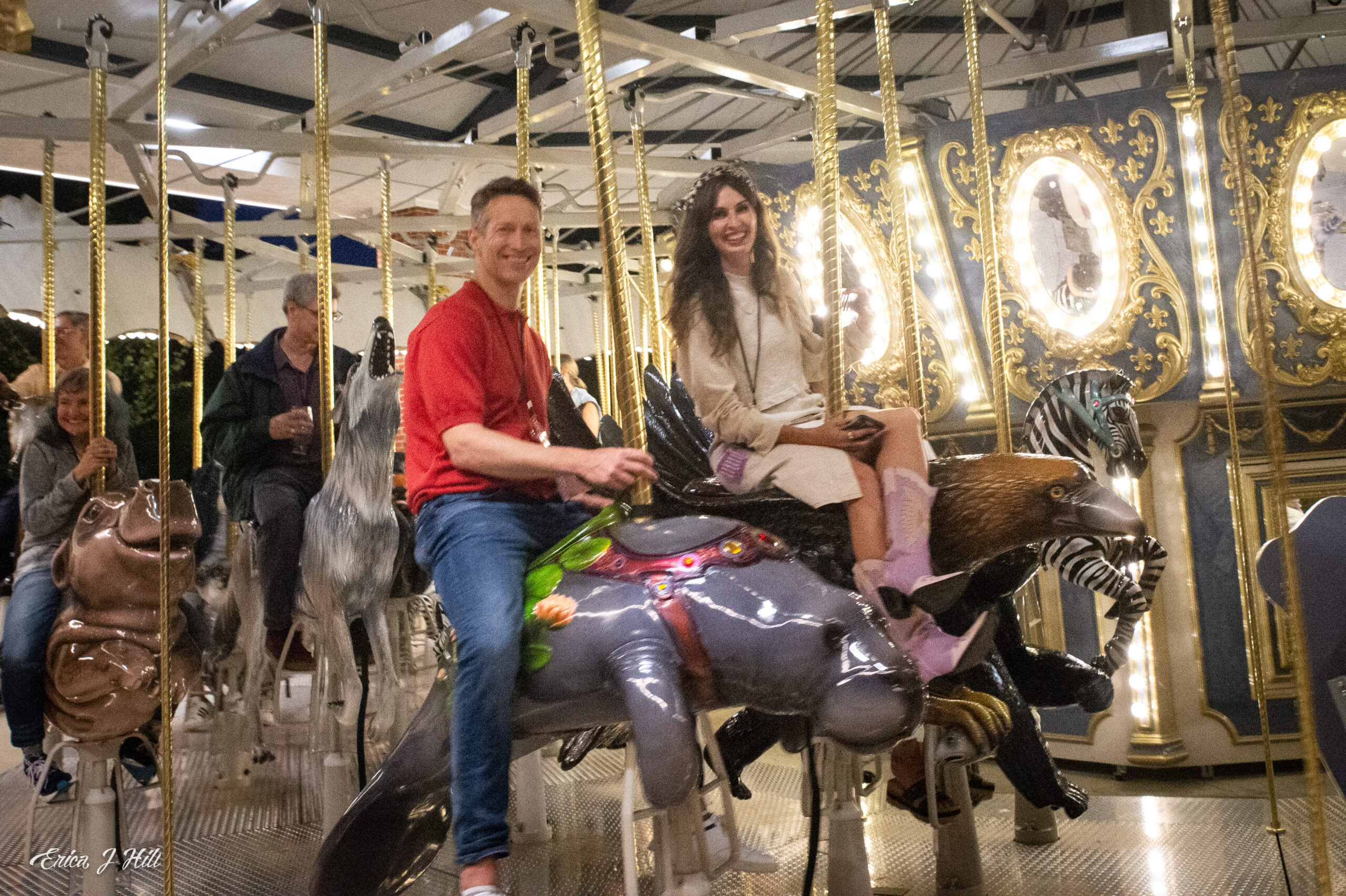 two guests riding the carousel at a zoo event