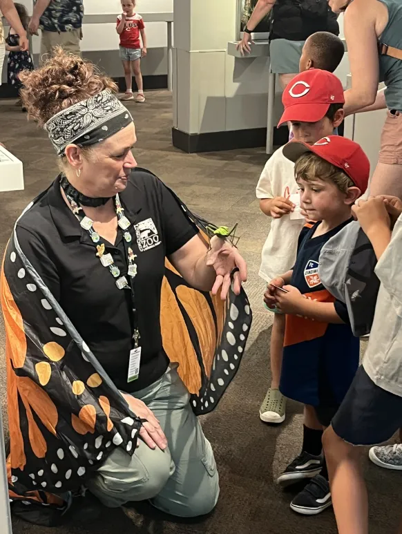 insect fest keeper showing kid an insect
