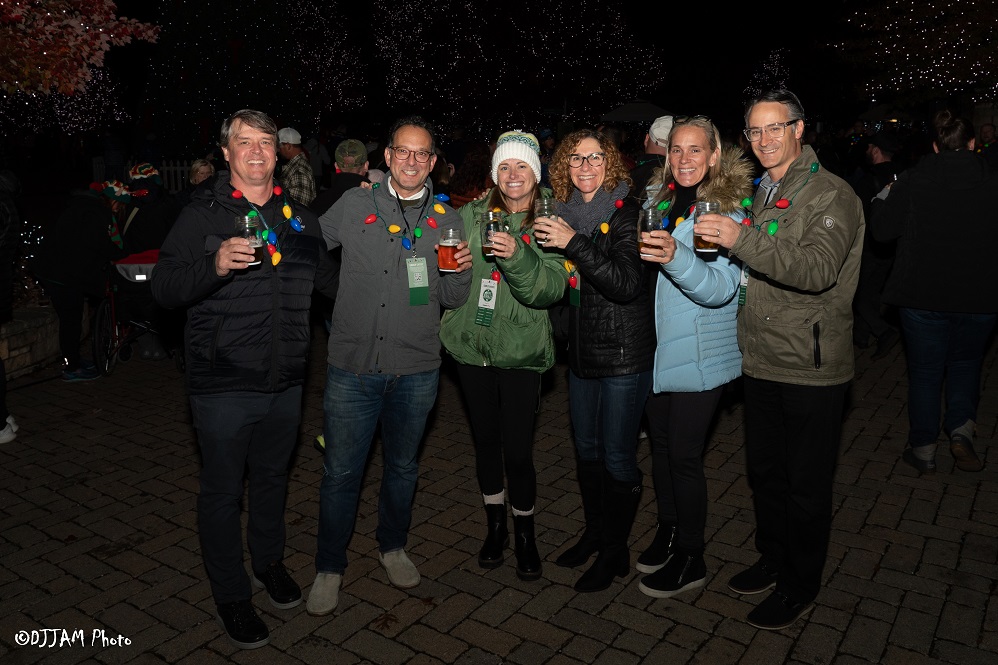 hops & holly guests wearing festive clothes posing for photo