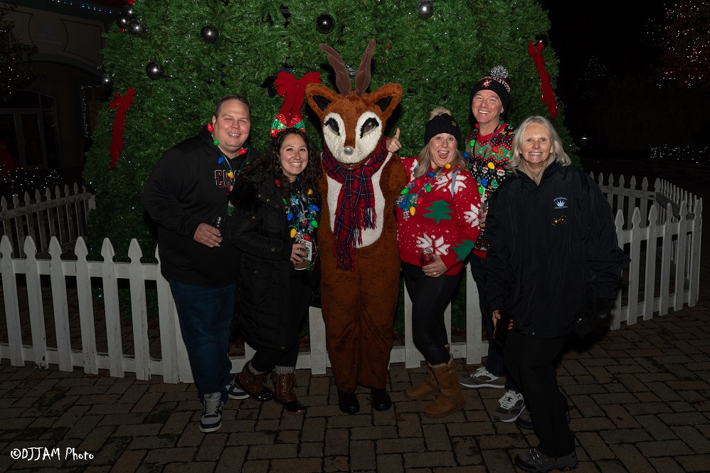 hops & holly guests wearing festive clothes posing for photo