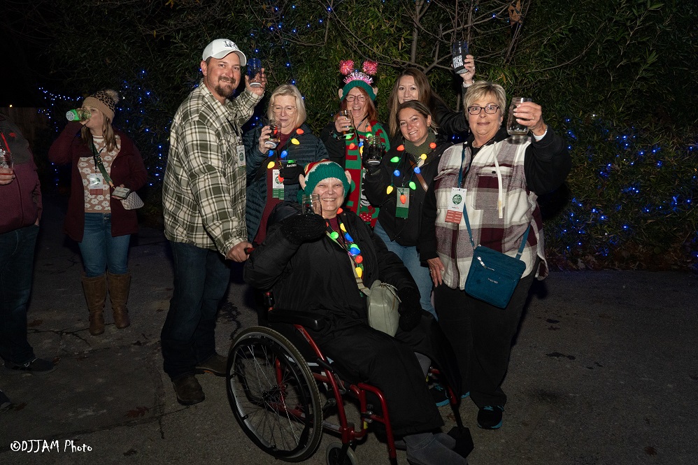 hops & holly guests wearing festive clothes posing for photo
