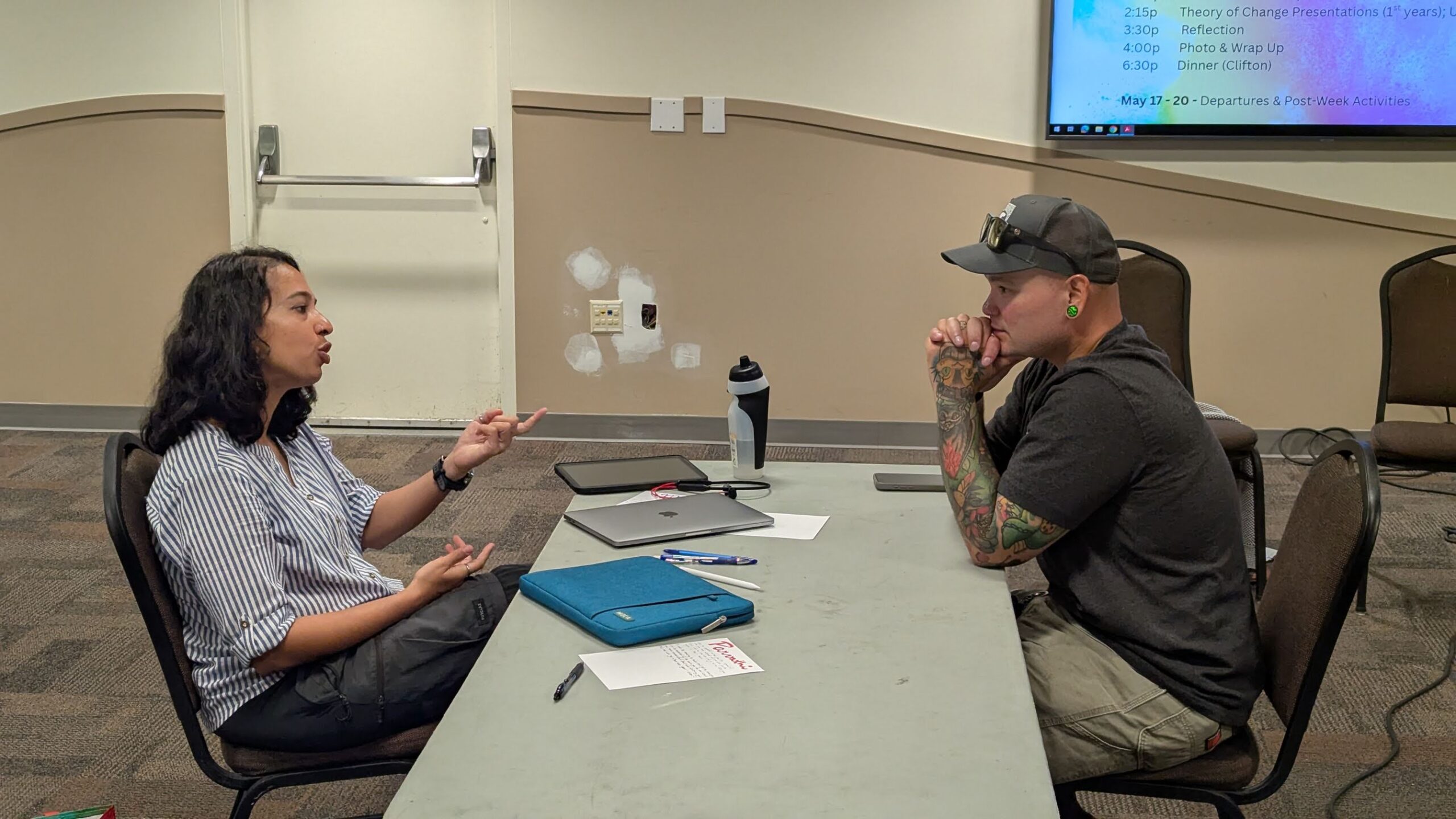 Joshua and Parvathi discussing solar lighting on the Indian tea estates