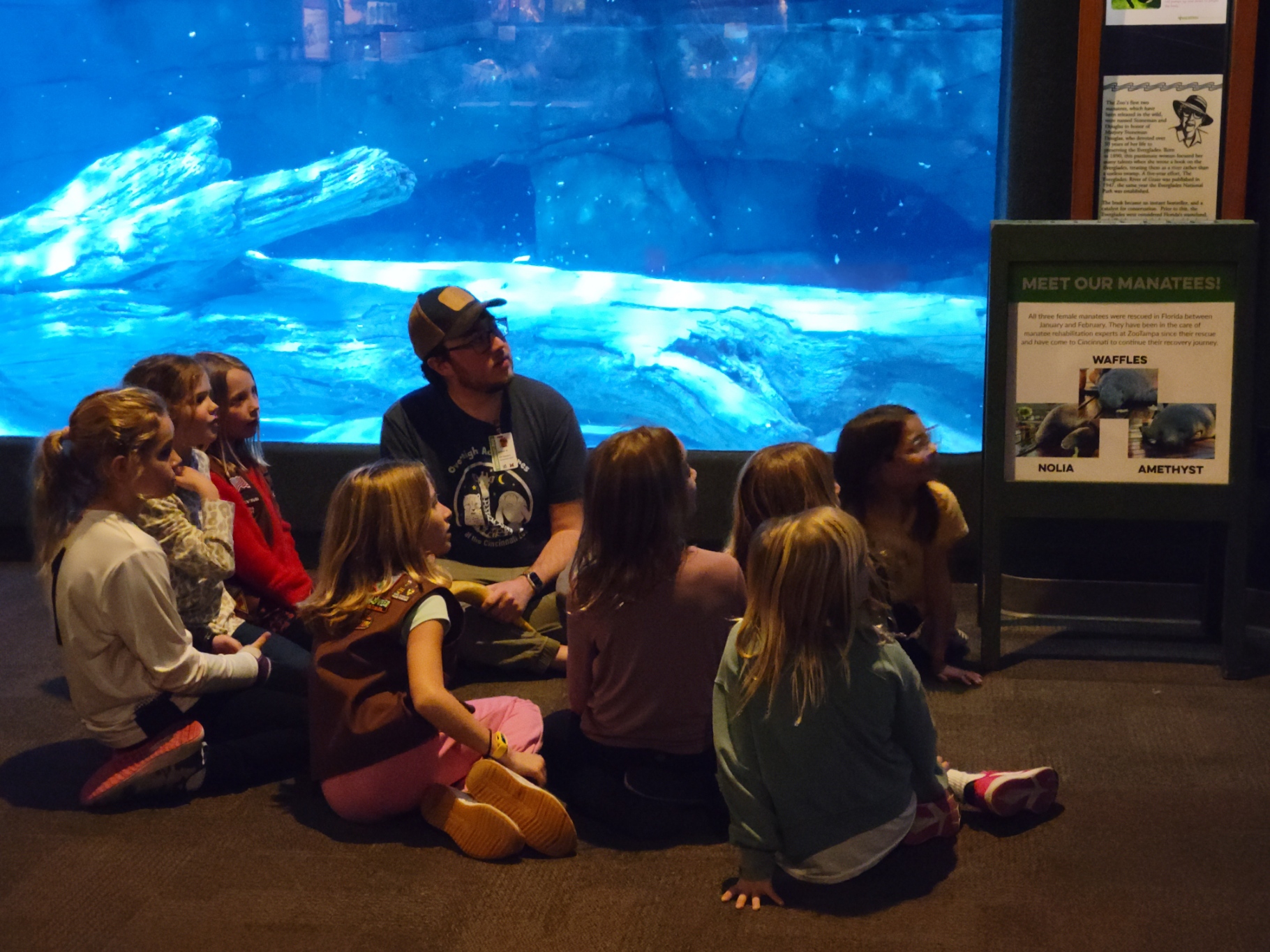 kids in front of the manatee pool with their overnight instructor