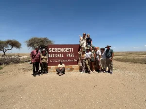 group photo in front of serengeti national park sign