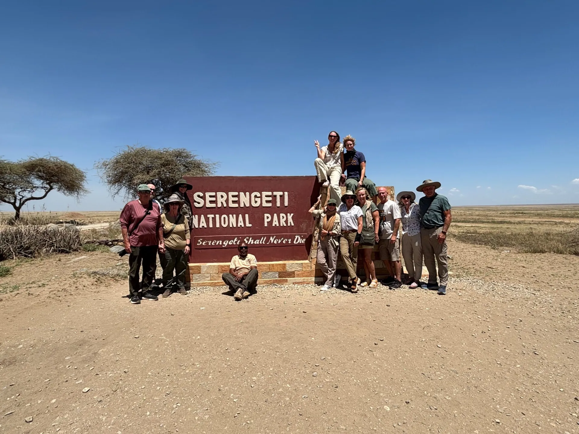 group photo in front of serengeti national park sign