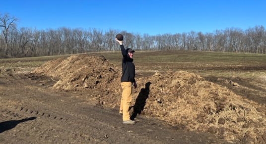 Zookeeper holding elephant dung
