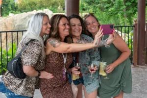 four women smiling for a selfie