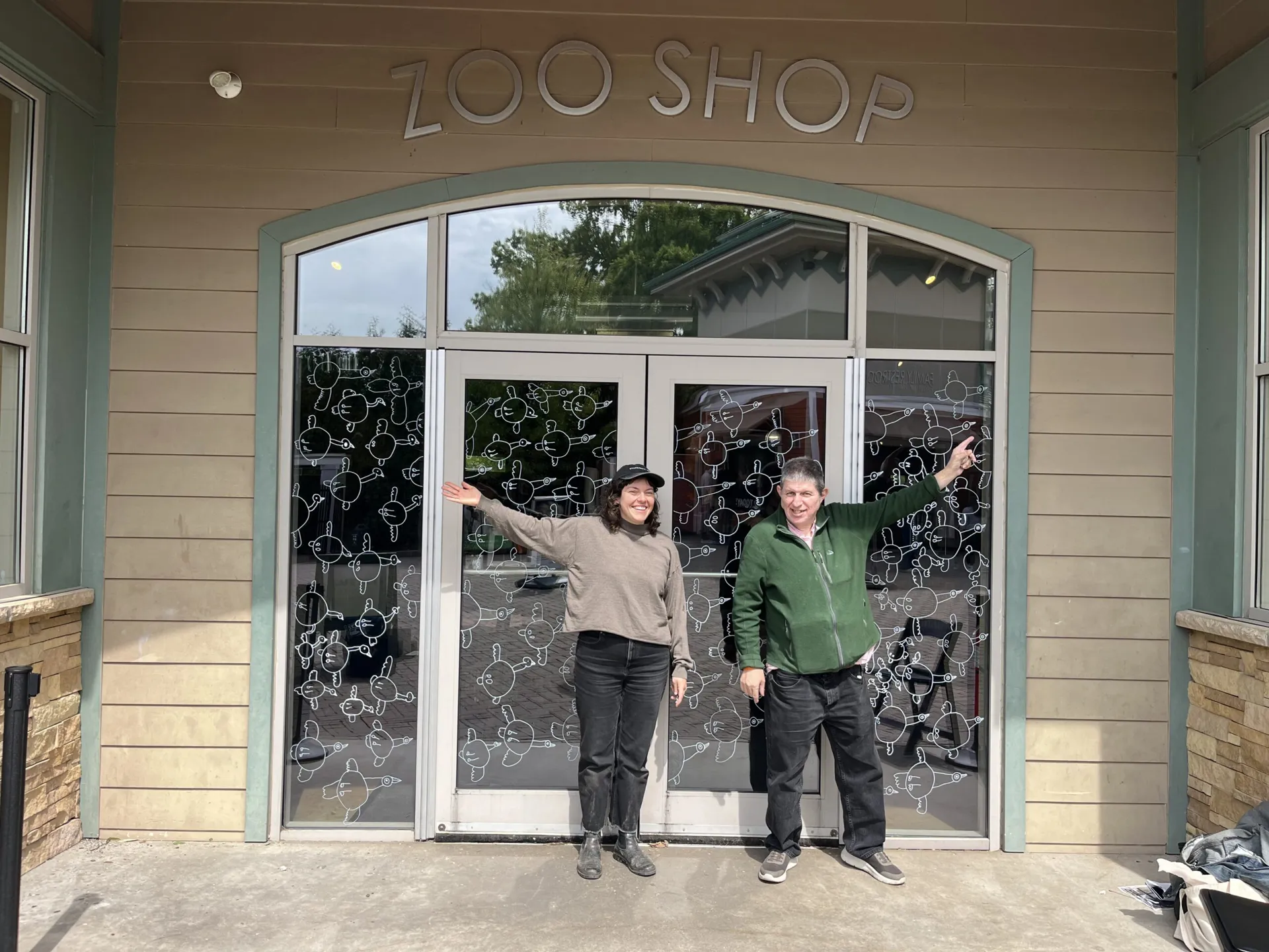 V+V creative director Lizzy DuQuette with artist Neil Dignan in front of his mural at the gift shop entrance. 