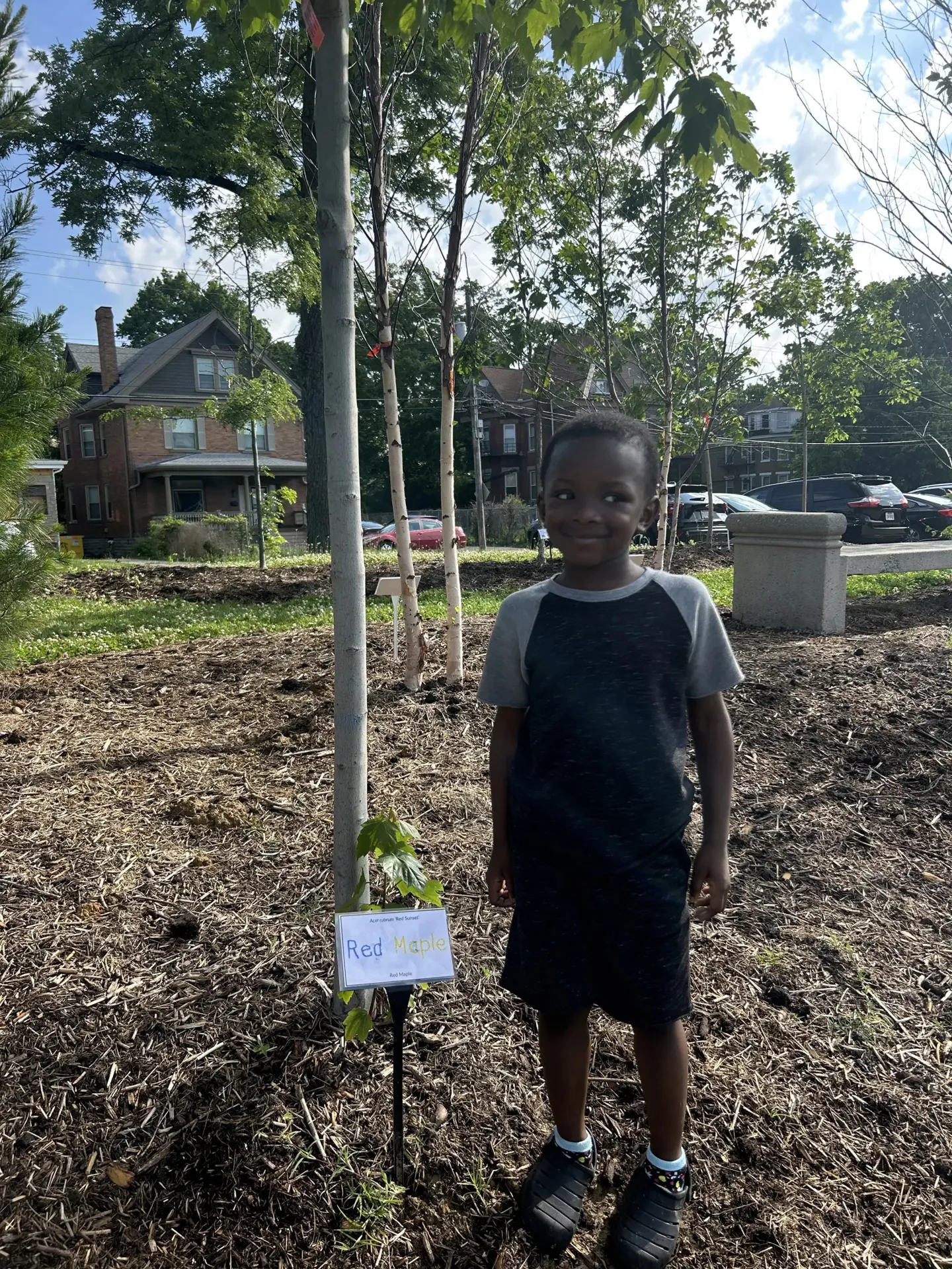 student at rockdale posing by tree